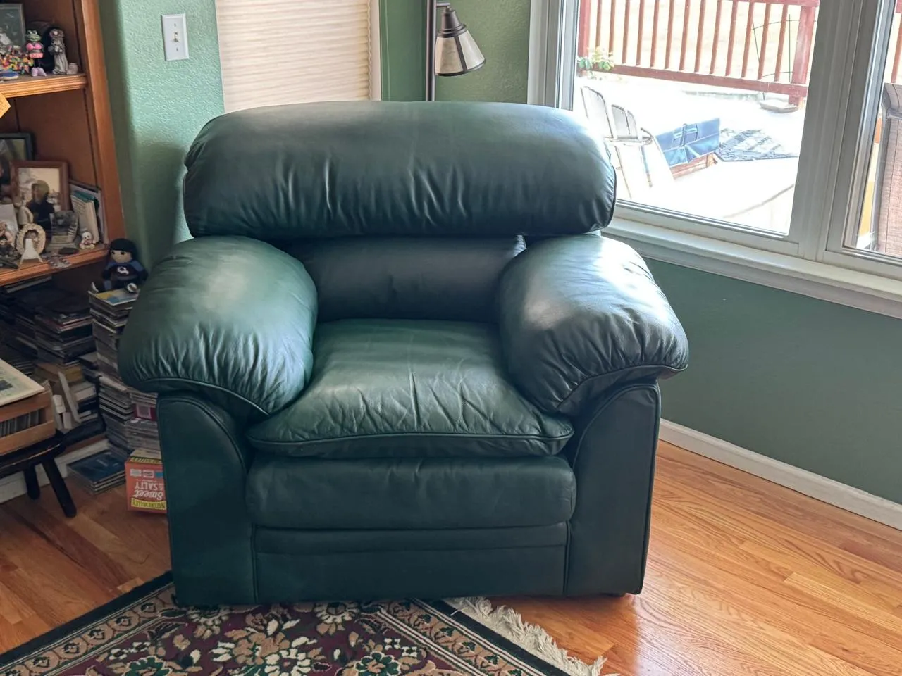 Green leather recliner in a living room